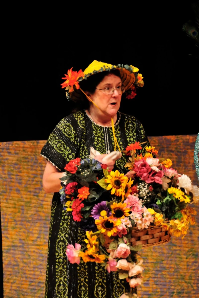 Variety Plus archive: a costumed performer carrying flowers